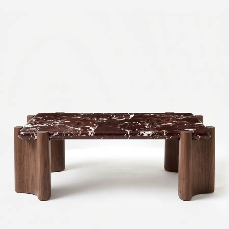 Draven Coffee Table coffee table — walnut wood sculpted column legs with a scalloped profile, set just beyond the corners of a rectangular top in Rosso…