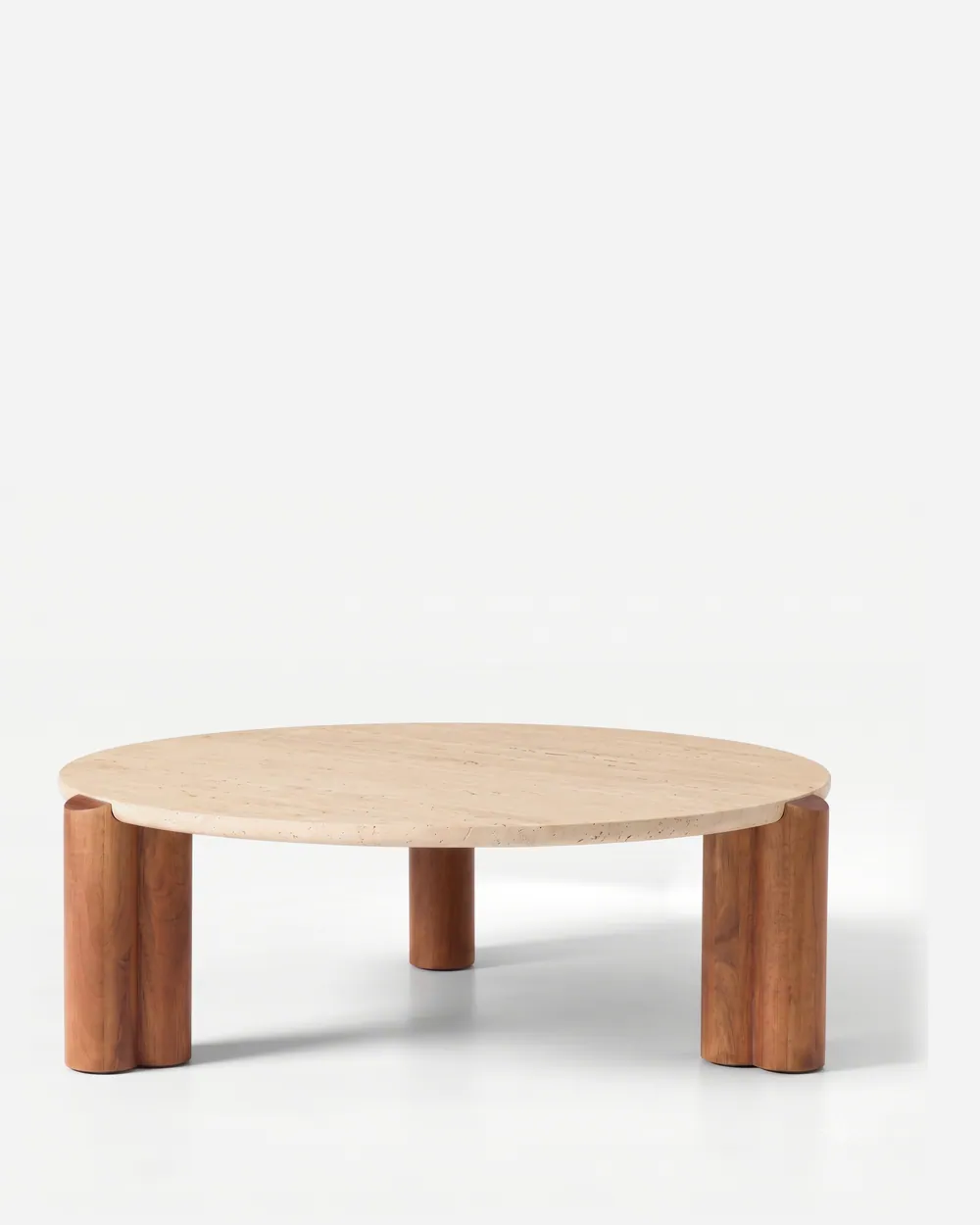 Nolan Coffee Table coffee table — round coffee table with a beige travertine top resting on three sculpted iroko wood legs in a walnut stain, each form…