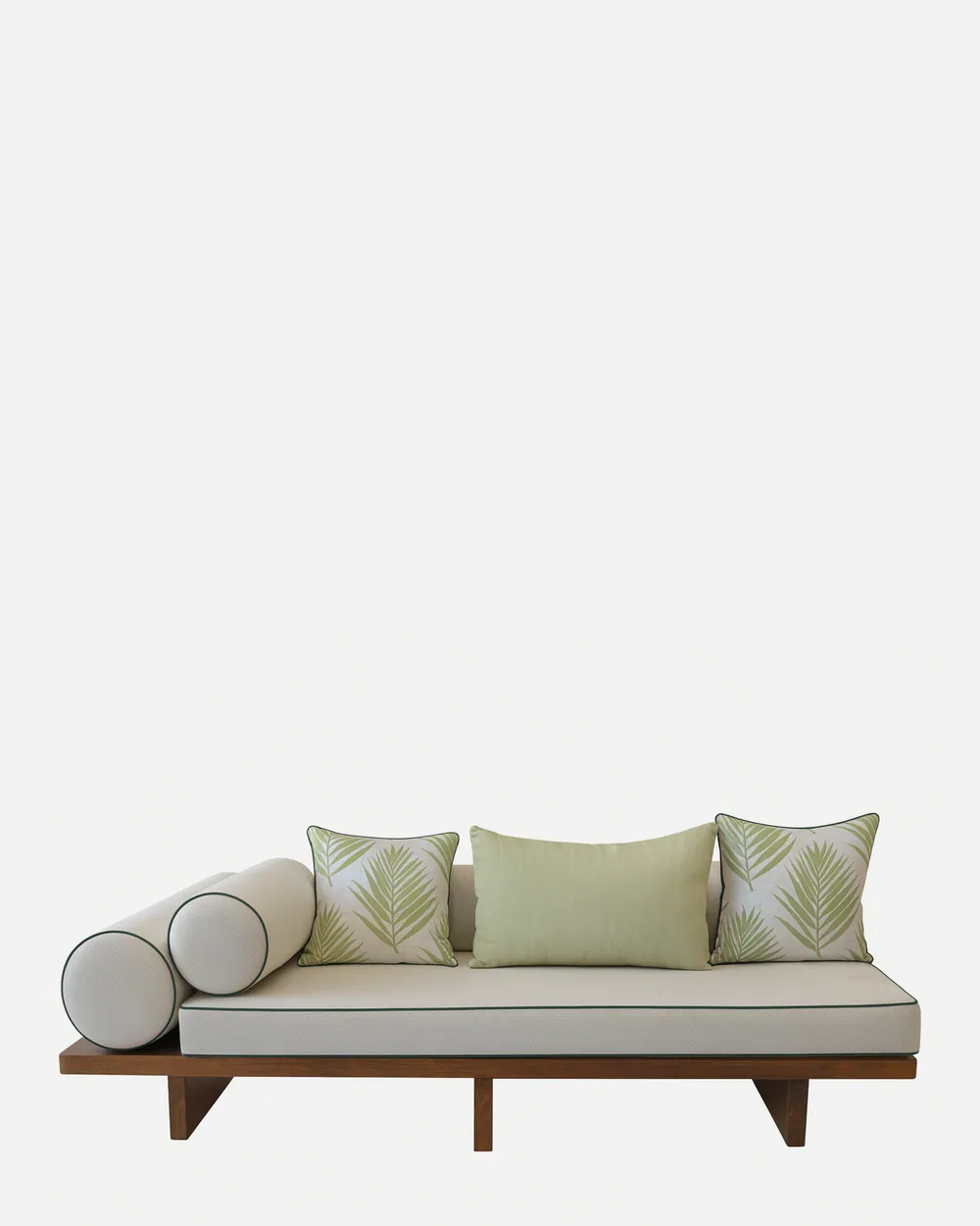 Terra daybed — iroko wood platform frame on slab legs, topped with a full-length mattress in plain fabric with contrast piping, two…