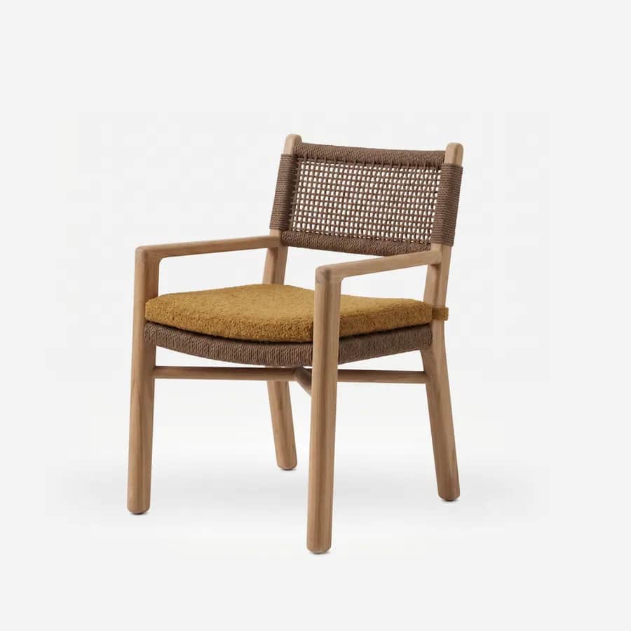 Bodhi Dining Chair dining chair — teak wood frame with open arms and crossed stretchers, a woven rope back and seat, and a tied-on seat cushion in a te…