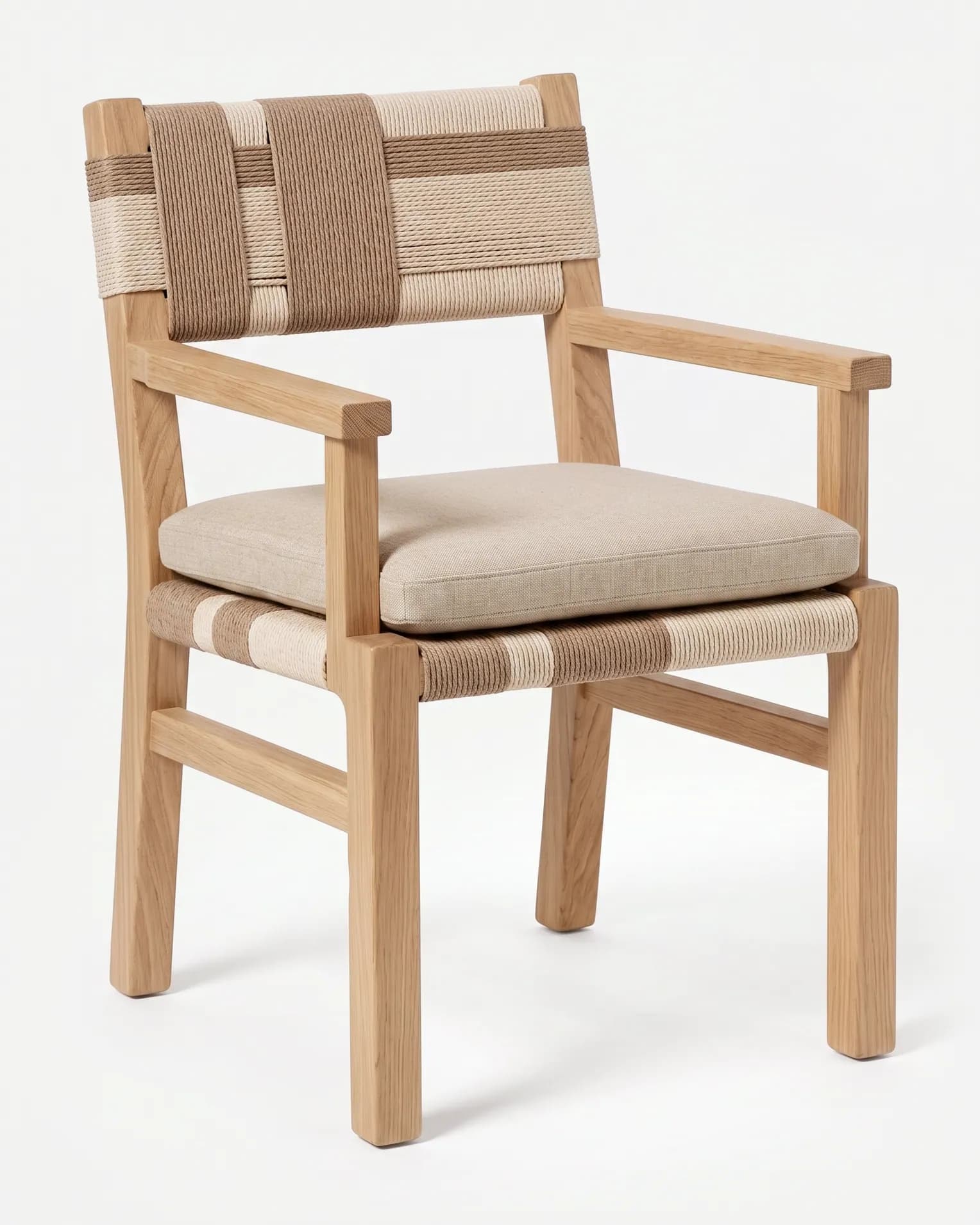 Lyra Dining Chair dining chair — teak wood frame with open arms and side rails, a back and seat woven in two-tone rope, and a loose seat cushion in pl…
