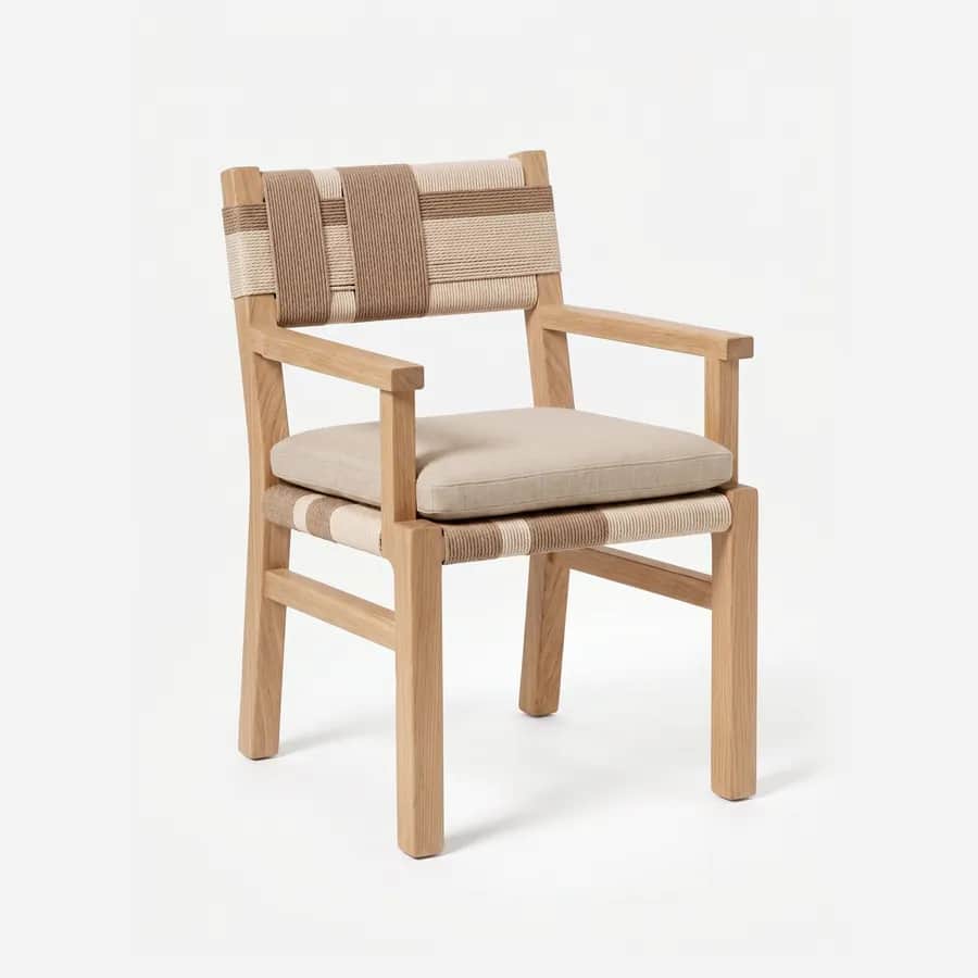Lyra Dining Chair dining chair — teak wood frame with open arms and side rails, a back and seat woven in two-tone rope, and a loose seat cushion in pl…