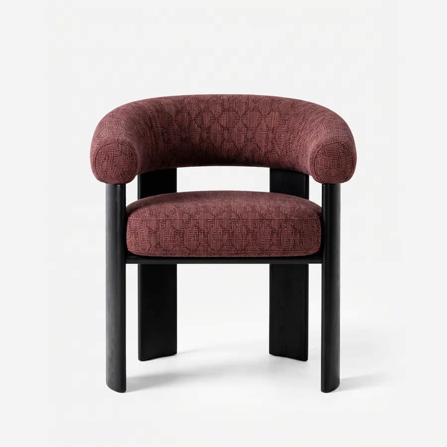 Nuvia Dining Chair dining chair — red oak open grain frame in a charcoal stain, upholstered in pattern fabric, with broad plank legs and a thick rounde…
