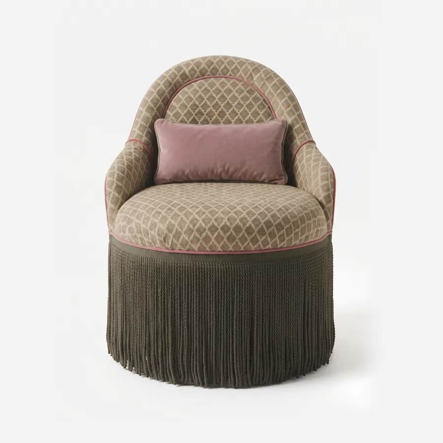 Wiro Dining Chair dining chair — fully upholstered tub form in pattern fabric with contrast piping, a rounded back wrapping into the sides, a loose lu…