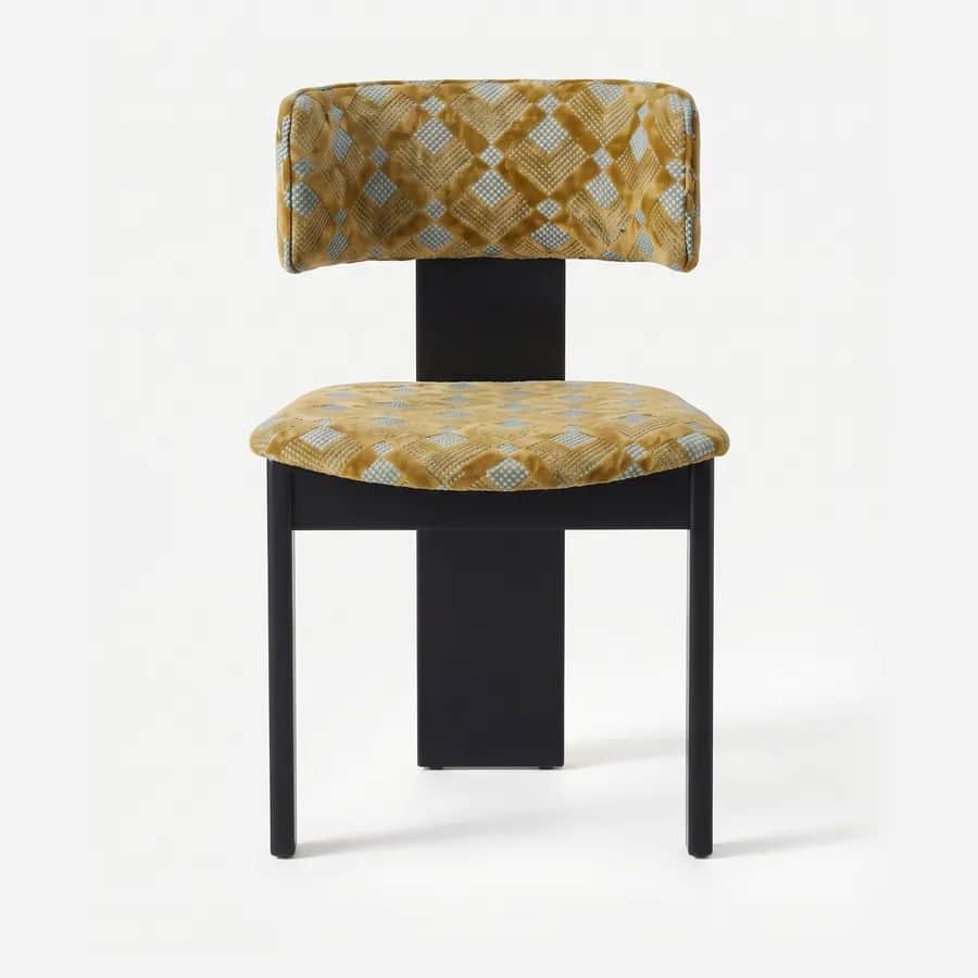 Zeno Dining Chair dining chair — iroko wood frame in a charcoal stain with slim square legs and a wide central spine, upholstered in pattern velvet, w…