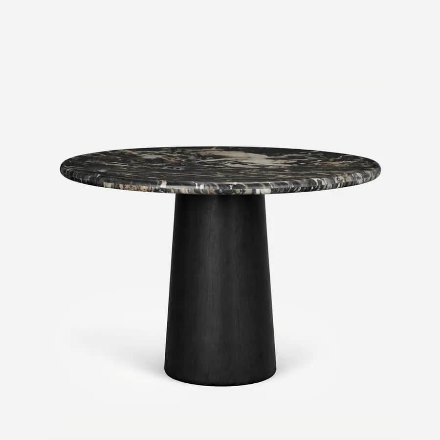 Akio Dining Table dining table — red oak open grain base in a charcoal stain, shaped as a tapered conical column, carrying a round Nero Marquina marbl…
