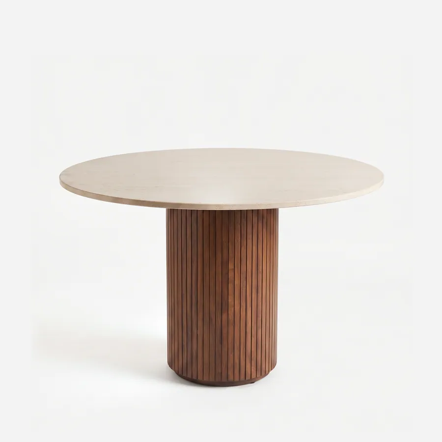 Bari Dining Table dining table — iroko wood in a walnut stain forms the wide drum base, clad in vertical fluted slats on a recessed plinth, beneath a…
