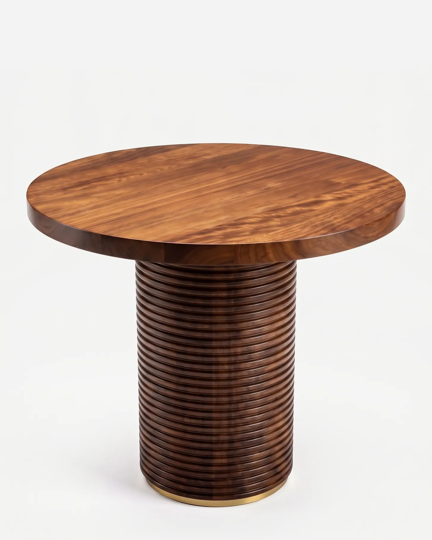 Dara Dining Table dining table — iroko wood in a walnut stain, with a figured round top on a broad drum pedestal of horizontal ribs, finished at the f…