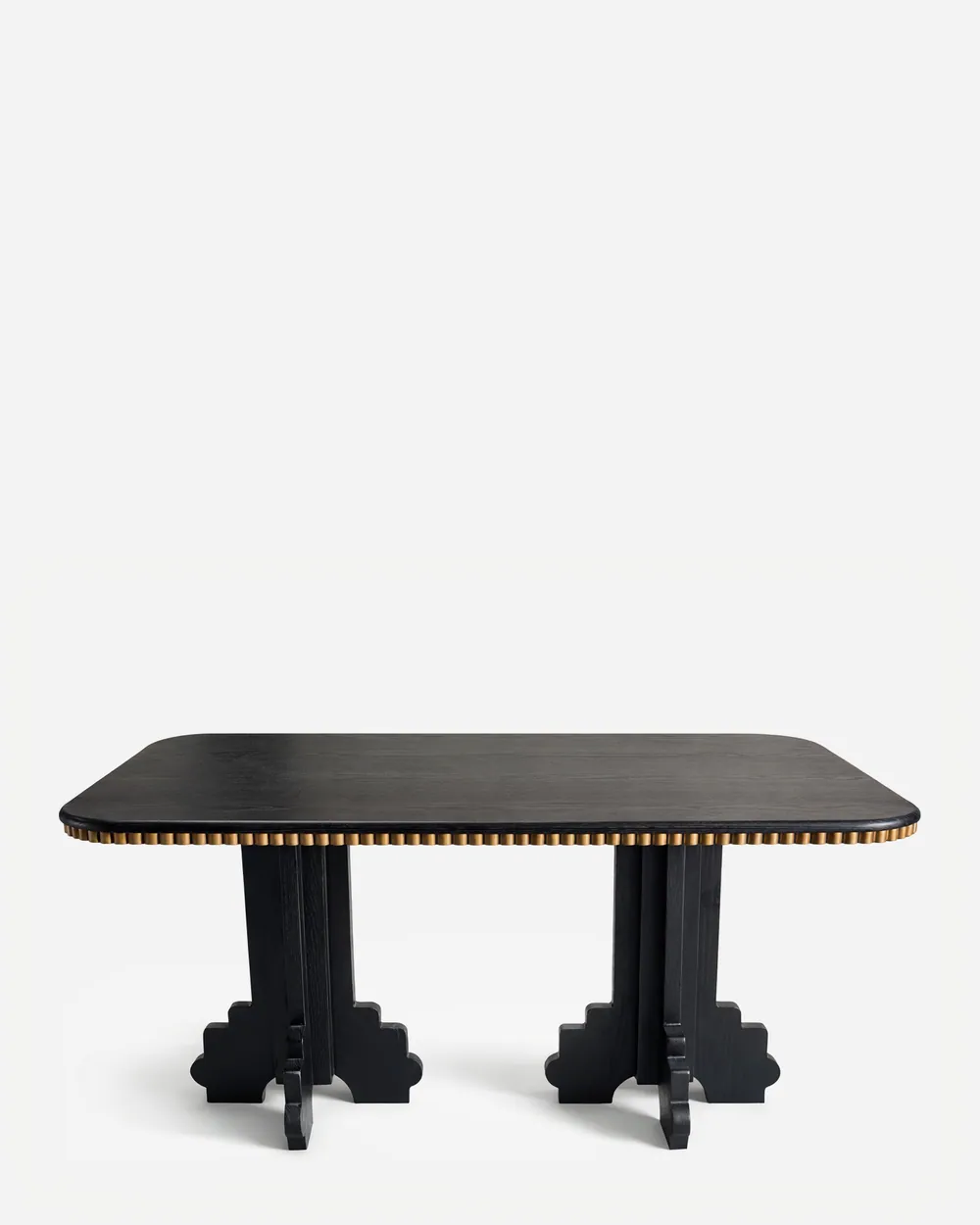 Haru Dining Table dining table — red oak open grain frame in a charcoal stain, with a rectangular top edged in a row of studs in electroplated brass-a…