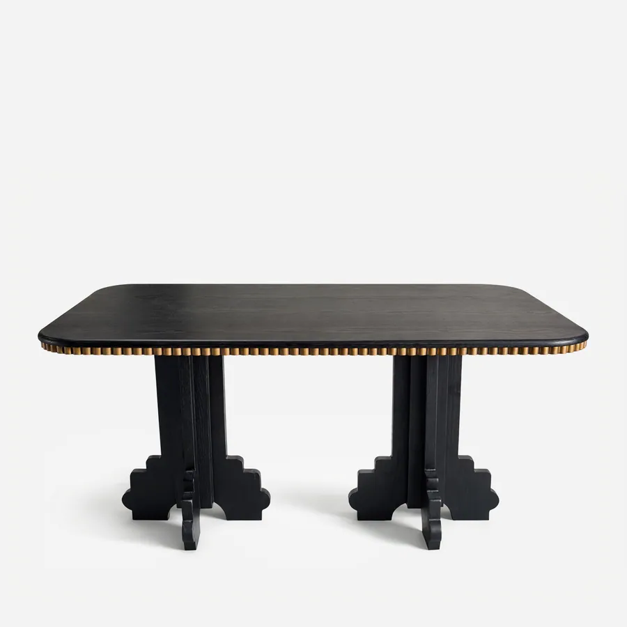 Haru Dining Table dining table — red oak open grain frame in a charcoal stain, with a rectangular top edged in a row of studs in electroplated brass-a…