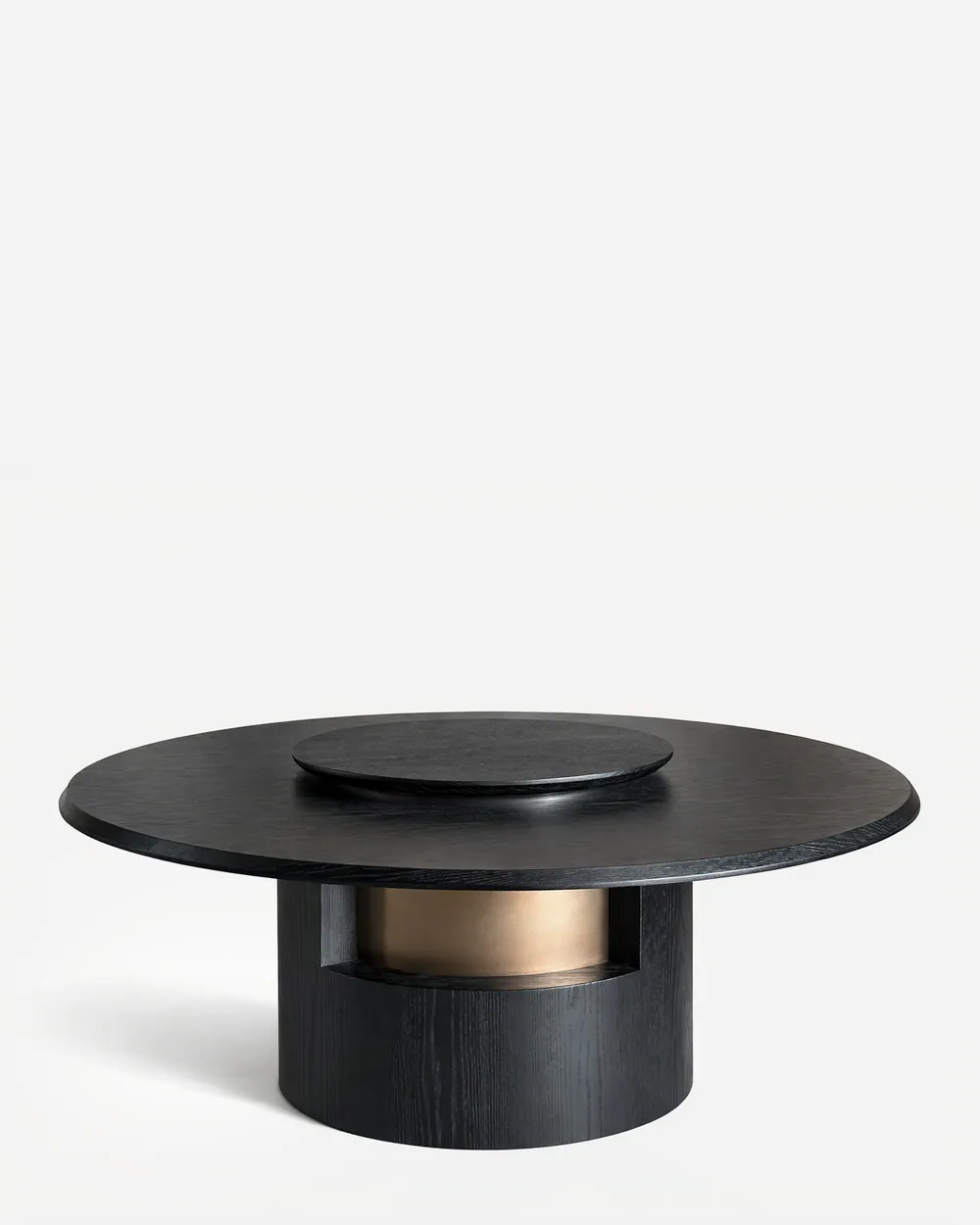 Kenzo Dining Table dining table — red oak open grain frame in a charcoal stain, with a round top and raised central turntable on a column base cut away…
