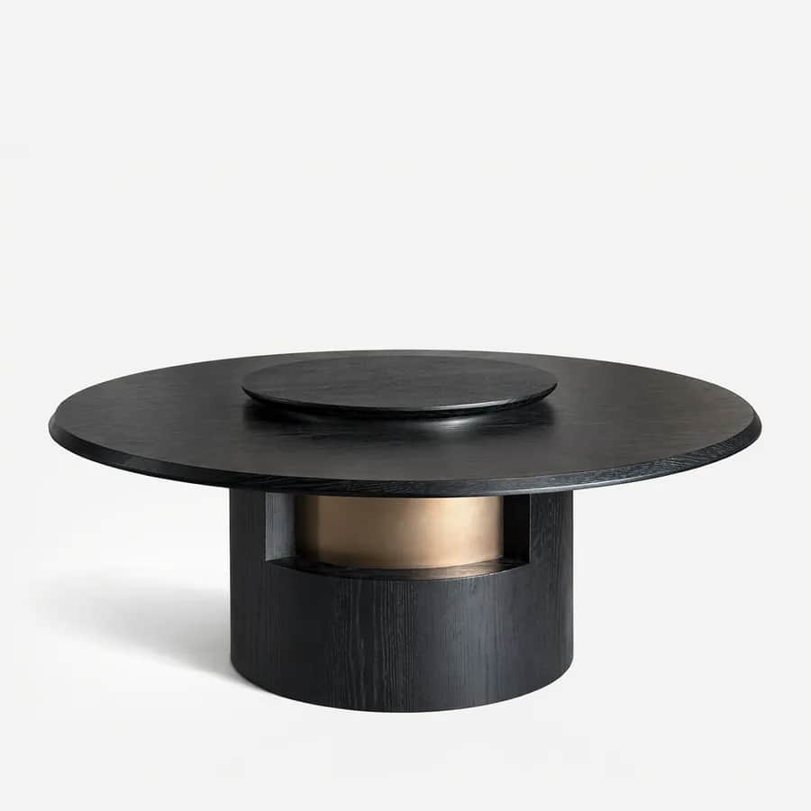 Kenzo Dining Table dining table — red oak open grain frame in a charcoal stain, with a round top and raised central turntable on a column base cut away…