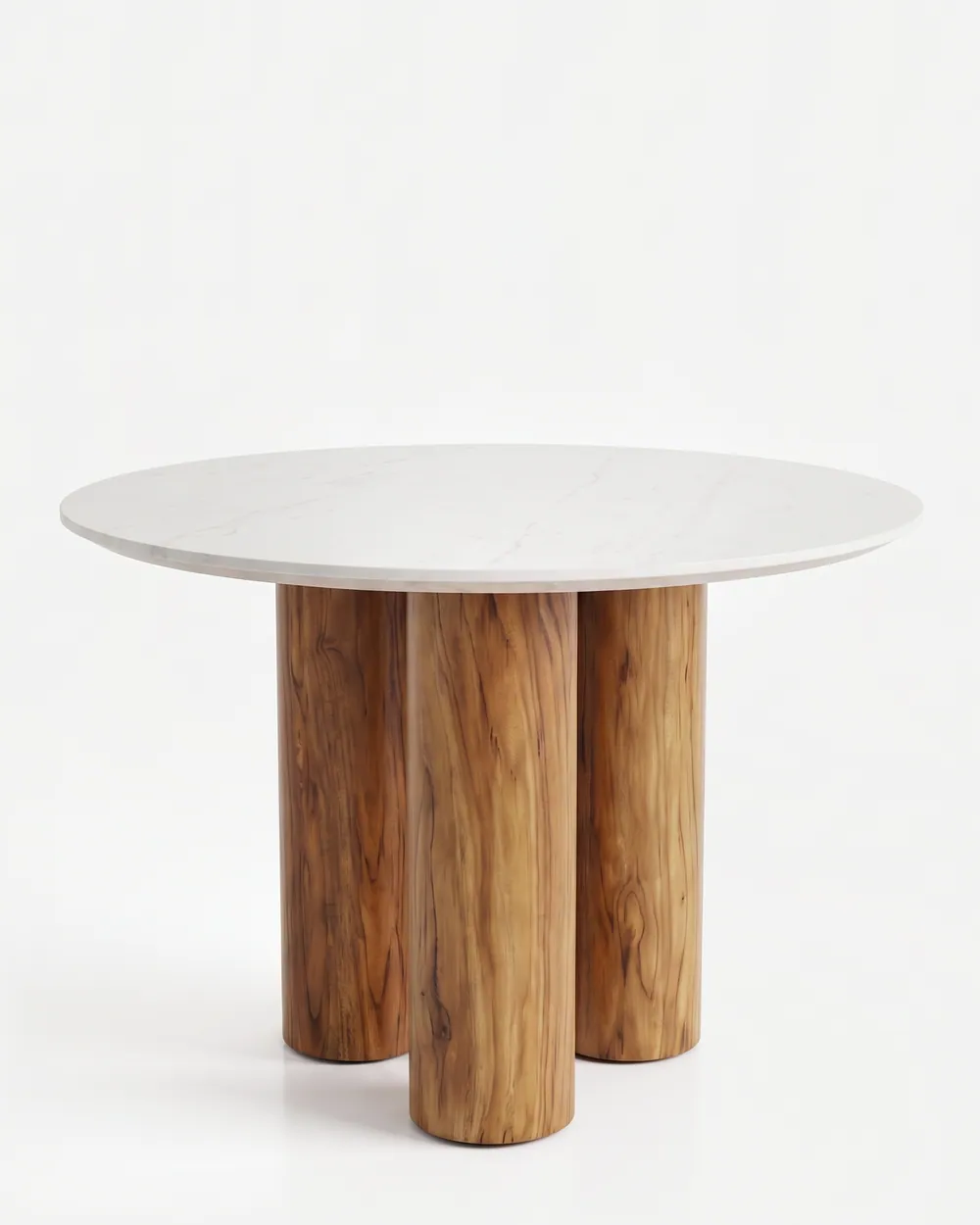 Liran Dining Table dining table — iroko wood in three cylindrical legs gathered closely beneath the centre, supporting a round Carrara marble top with…
