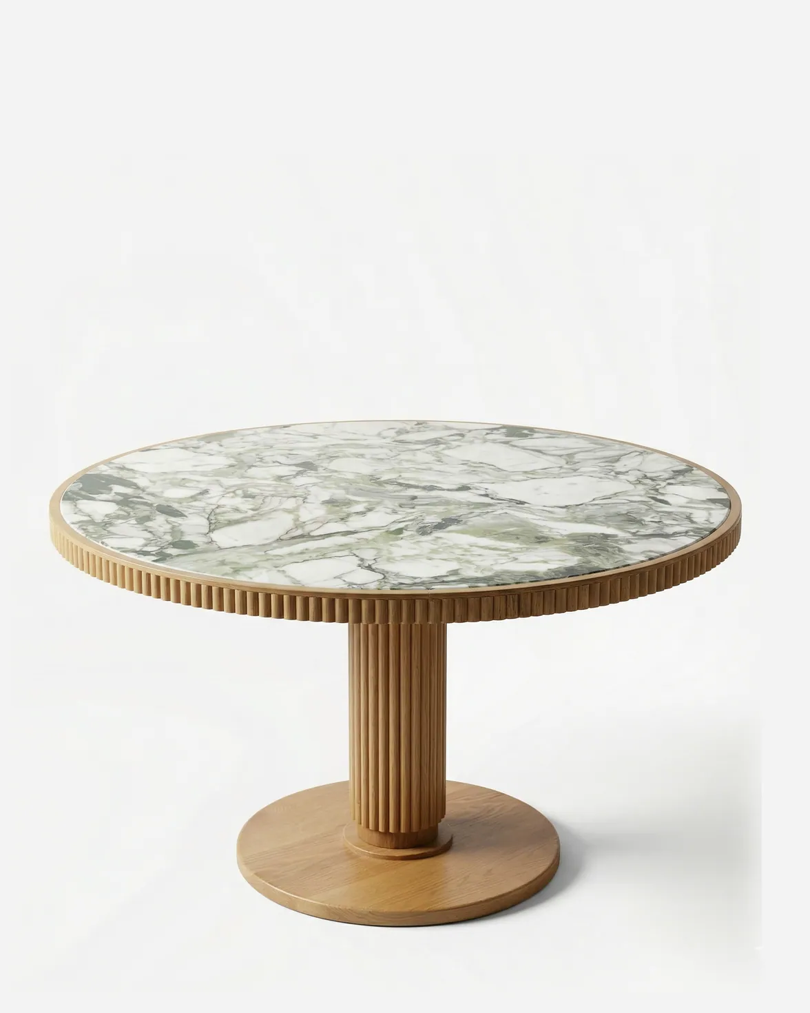 Mika Dining Table dining table — ash wood frame in a natural finish, with a reeded edge band around a round Sienna Verde marble top, set on a fluted c…