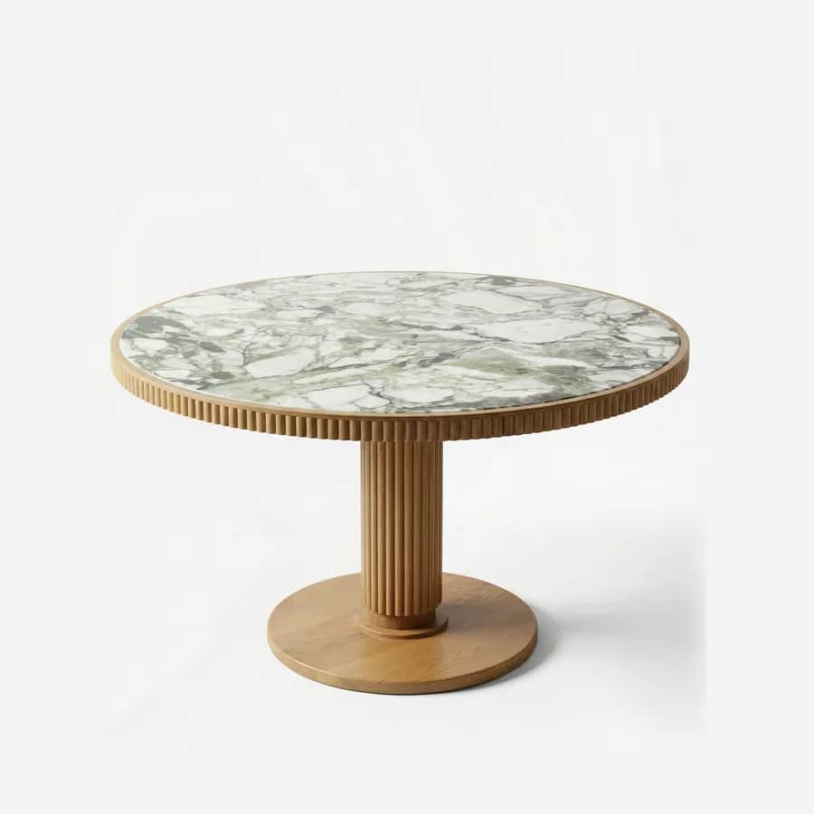 Mika Dining Table dining table — ash wood frame in a natural finish, with a reeded edge band around a round Sienna Verde marble top, set on a fluted c…