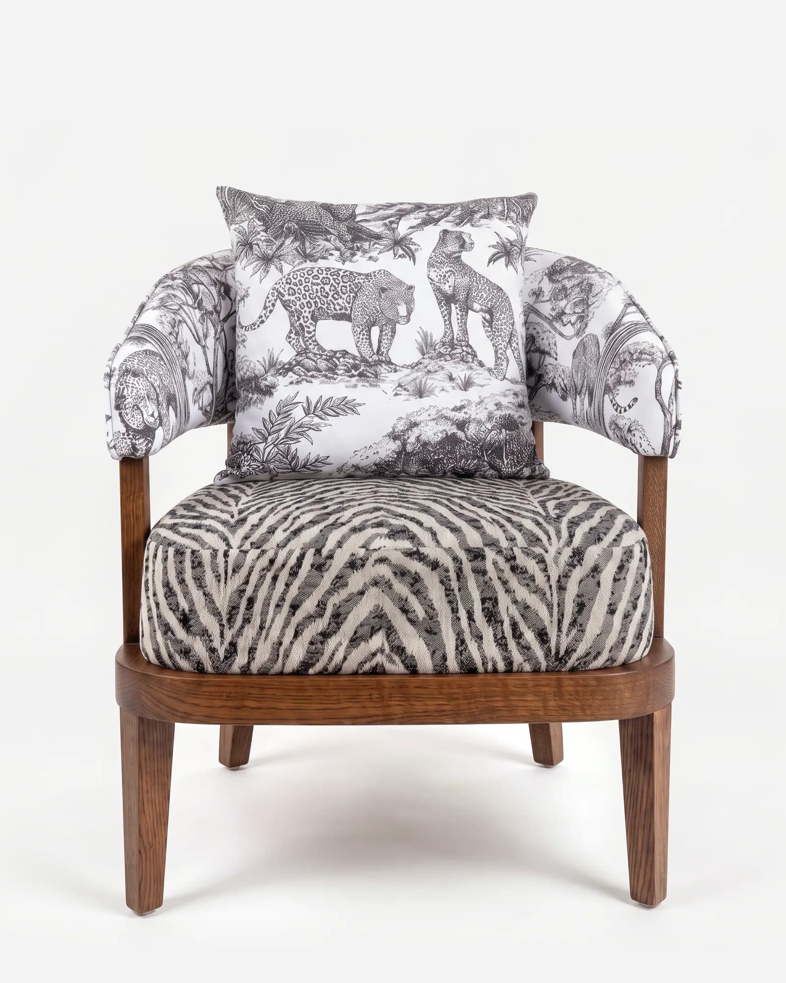 Panther Lounge Chair lounge chair — red oak open grain frame in a walnut stain, upholstered in pattern fabric, with a rounded seat rail, arm posts rising…