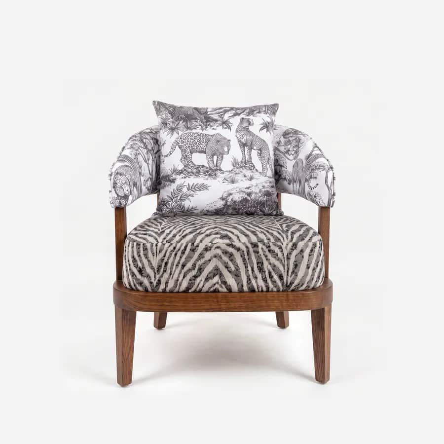 Panther Lounge Chair lounge chair — red oak open grain frame in a walnut stain, upholstered in pattern fabric, with a rounded seat rail, arm posts rising…