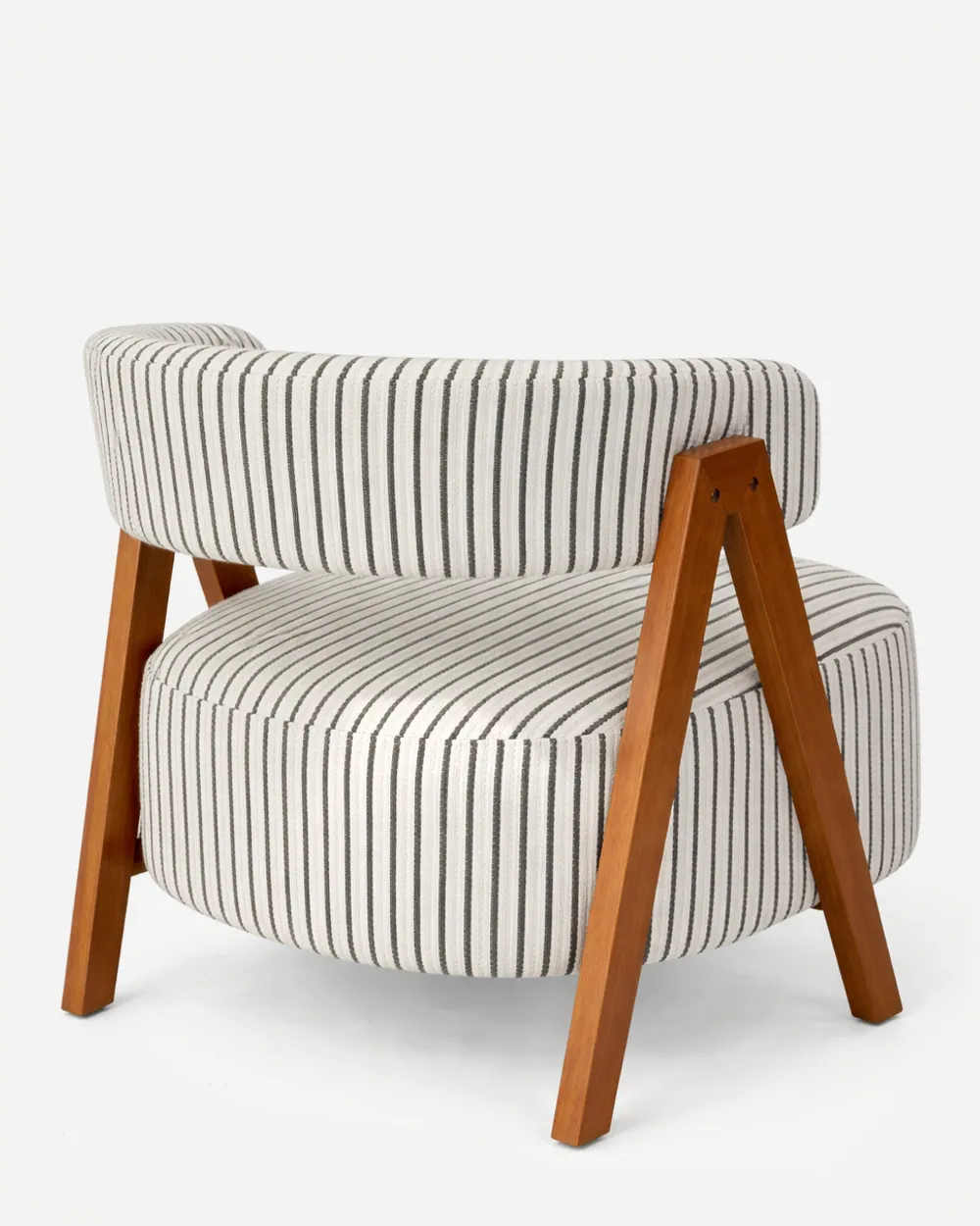 Coro lounge chair — a compact lounge chair featuring a solid iroko wood frame with an oiled finish, paired with upholstered seat and back…