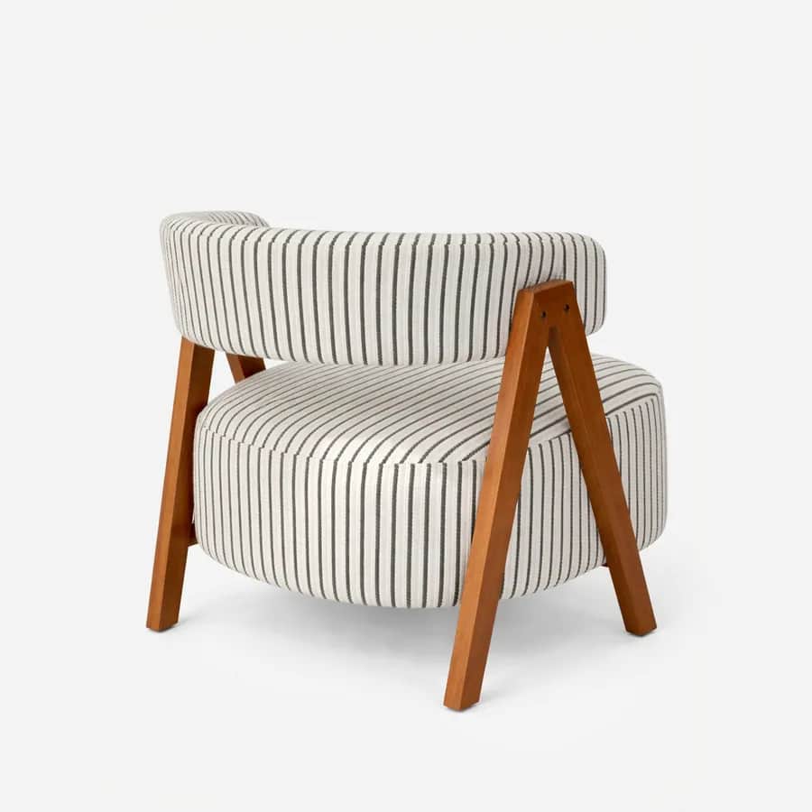 Coro lounge chair — a compact lounge chair featuring a solid iroko wood frame with an oiled finish, paired with upholstered seat and back…