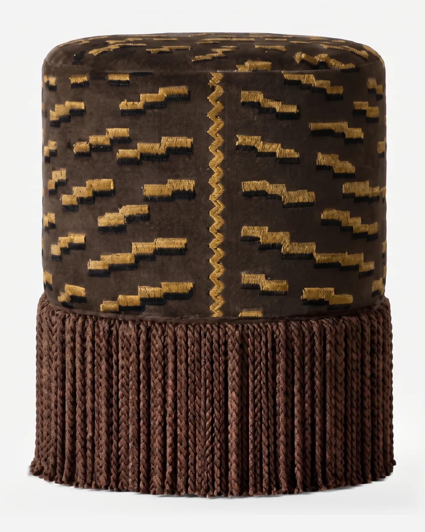 Lumo Pouf pouf — cylindrical, fully upholstered pouf in pattern velvet with a raised geometric motif and a central zigzag trim, finish…