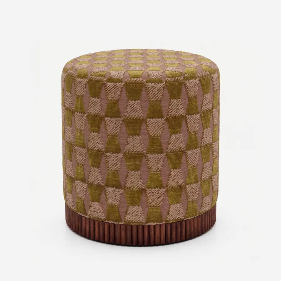 Tilo Pouf pouf — walnut wood fluted base beneath a cylindrical body upholstered in pattern velvet, with a raised geometric motif on a…