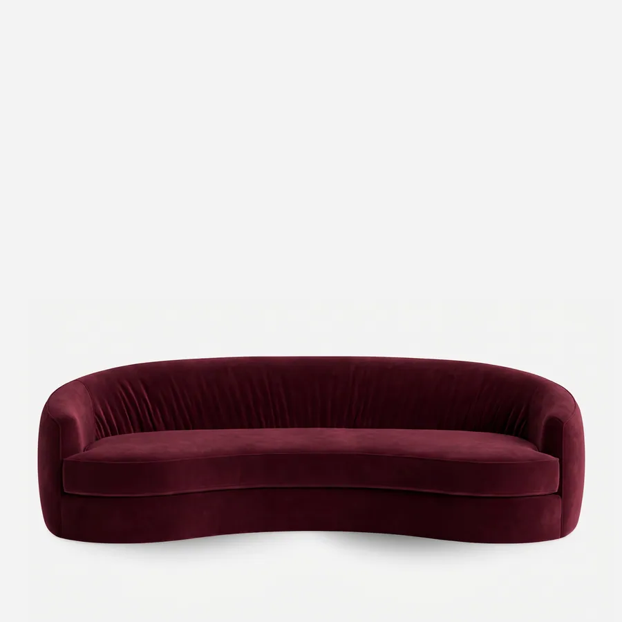 Emere Sofa sofa — curved sofa fully upholstered in velvet, with a rounded back wrapping into the sides, a gathered inner back and a lon…