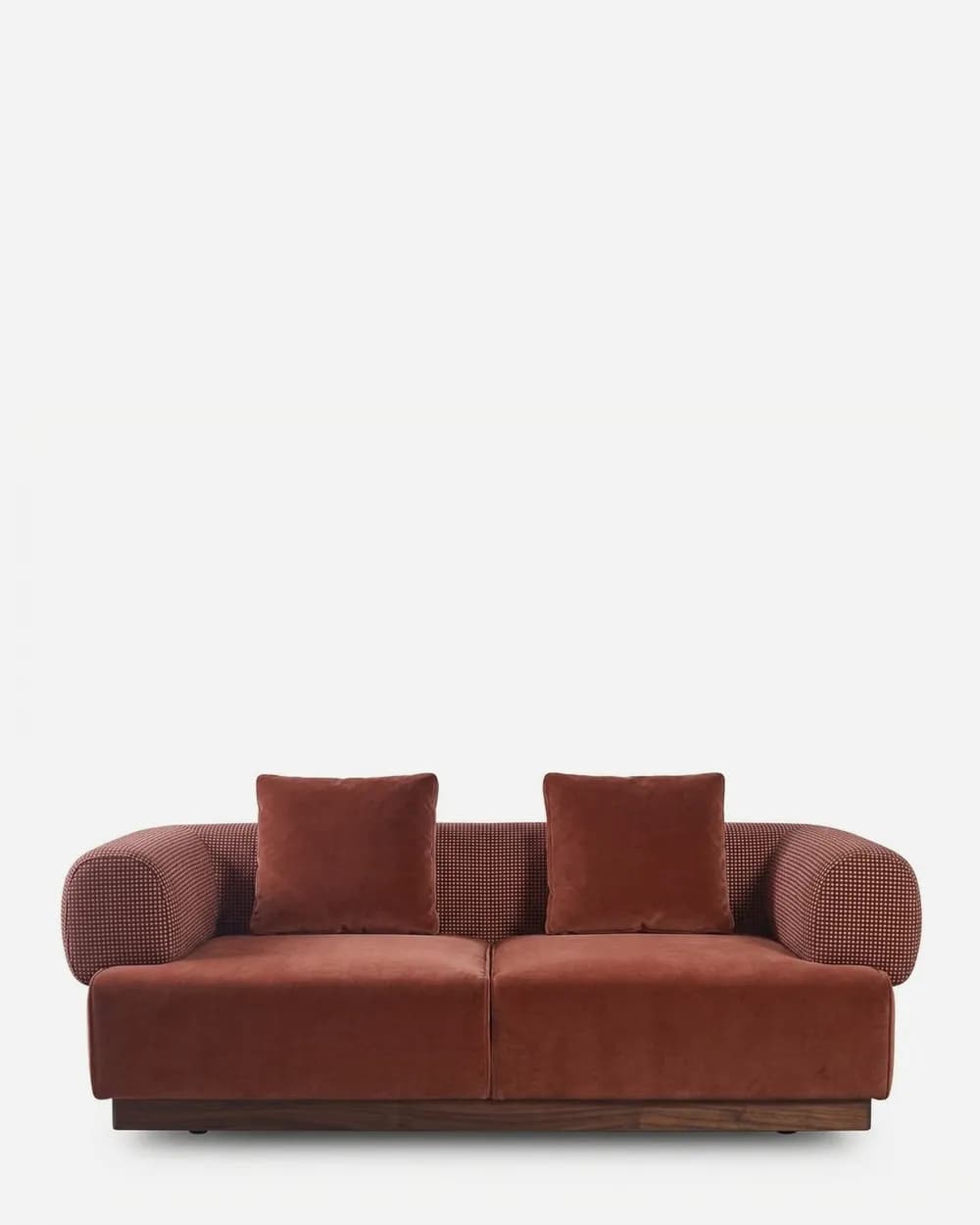 Lume Sofa sofa — walnut wood plinth base under a two-seat body in pattern fabric, with velvet seat and back cushions and rounded bolst…