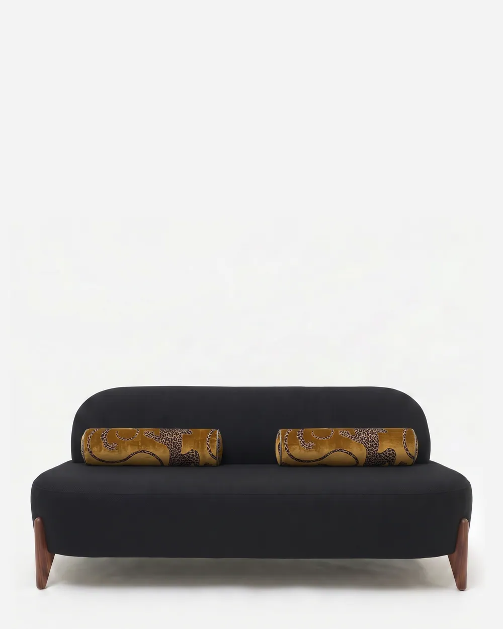 Solstice Sofa sofa — walnut wood splayed tapered legs under an armless body upholstered in plain fabric, with a softly rounded back and se…