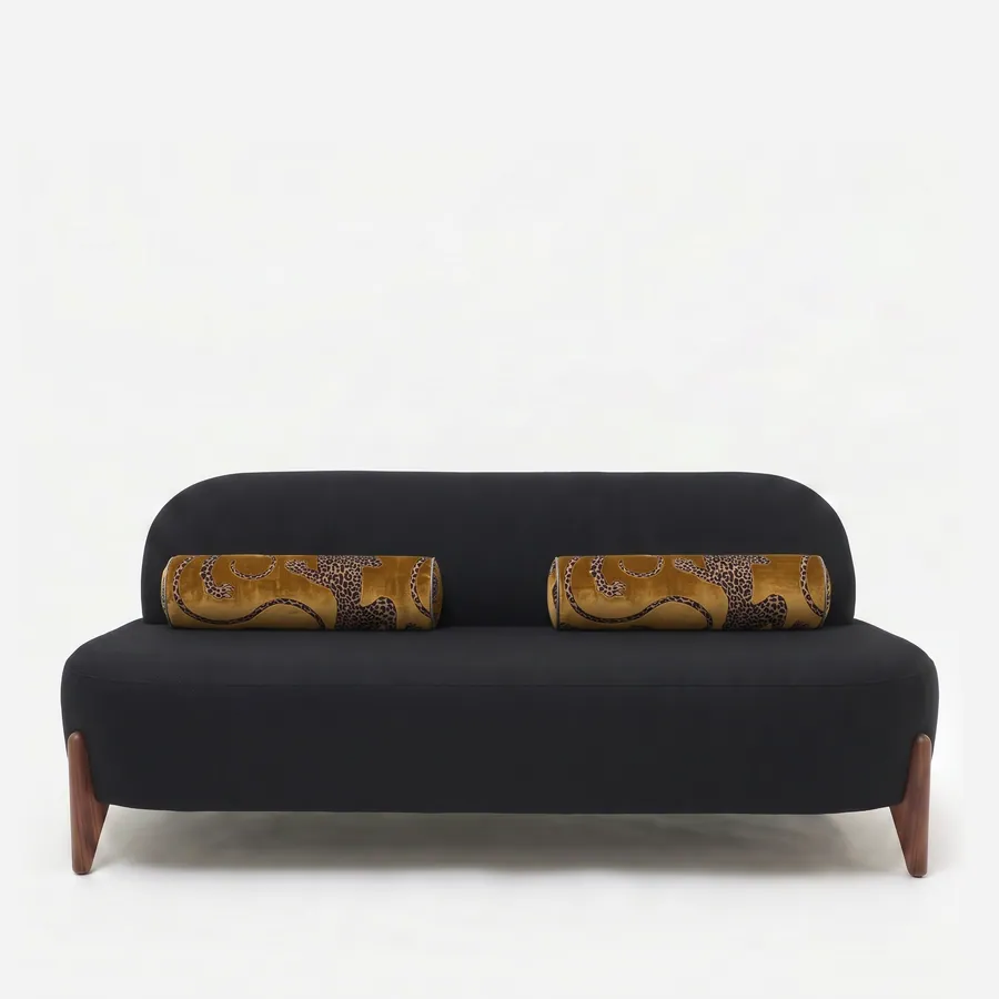 Solstice Sofa sofa — walnut wood splayed tapered legs under an armless body upholstered in plain fabric, with a softly rounded back and se…