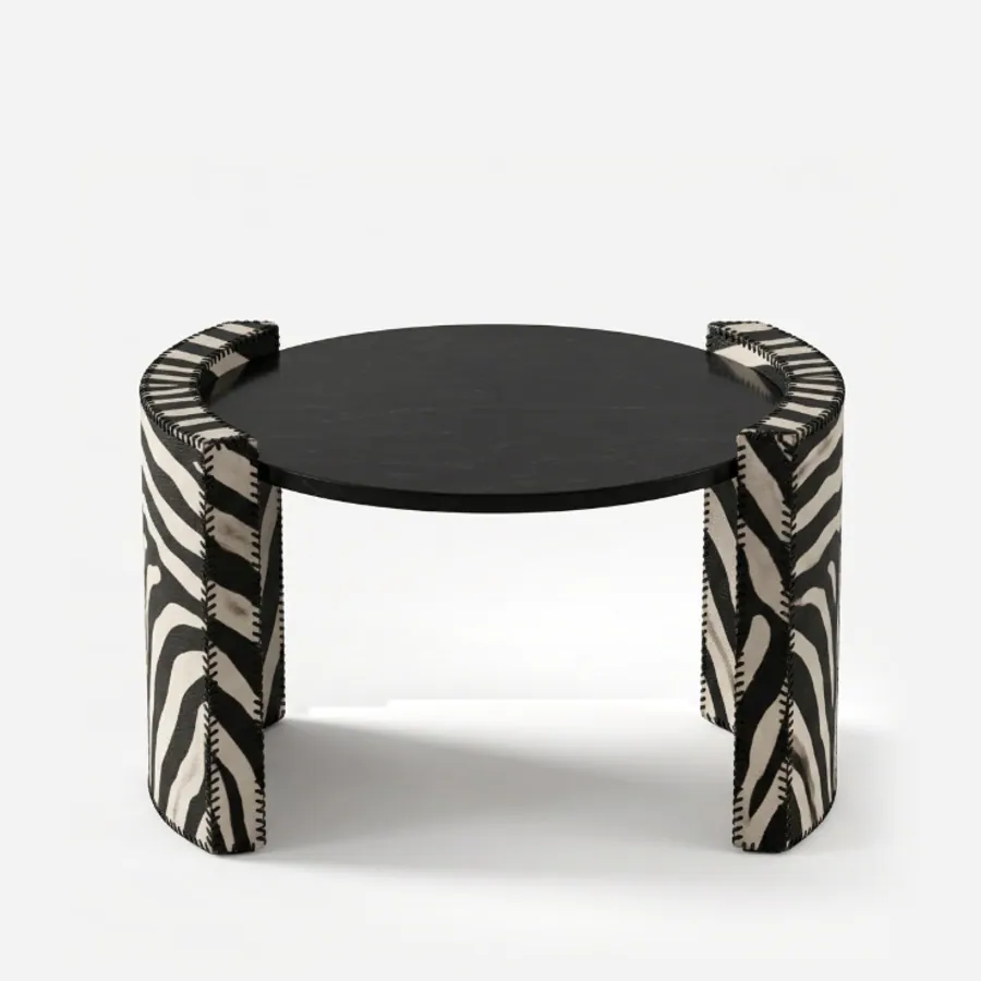 Neyra Side Table side table — nero Marquina marble round top carried on two curved, wraparound side supports covered in zebra-pattern leather with…