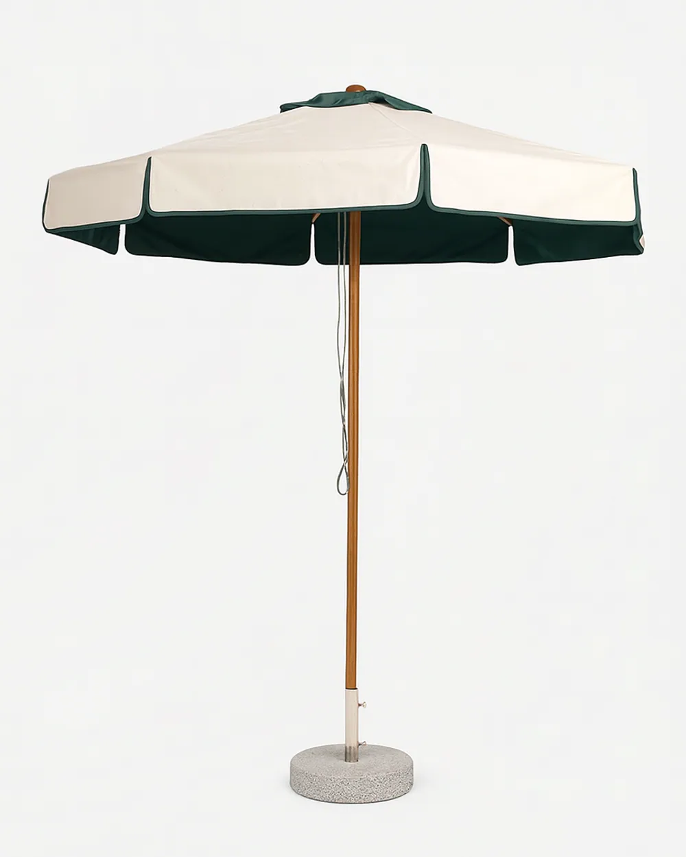 Siro umbrella — iroko wood centre pole carrying a round plain fabric canopy in cream with a contrast scalloped green valance, standin…