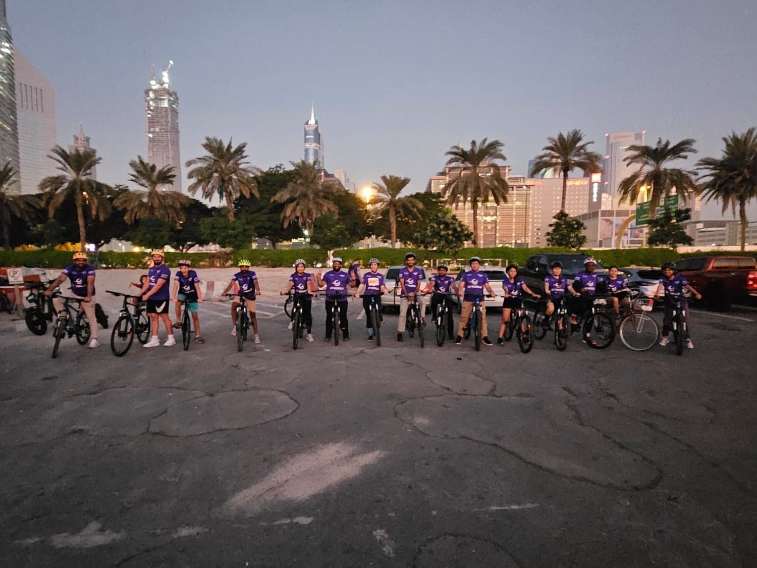 The team lined up on bicycles at dusk in Dubai